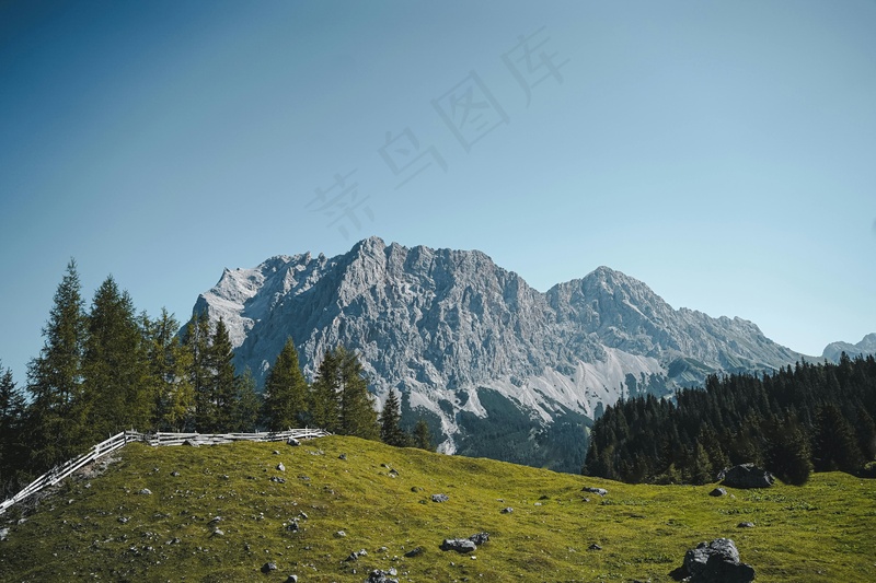 翠绿草坡与巍峨山巅的和谐