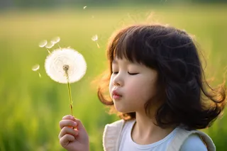 吹蒲公英的女孩可爱儿童绿色背景摄影图