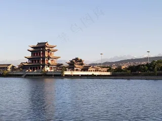 夕阳下的古建筑和雪山照片