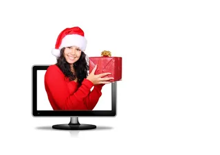 少妇在圣诞老人帽子的拿着礼物的抽象图象